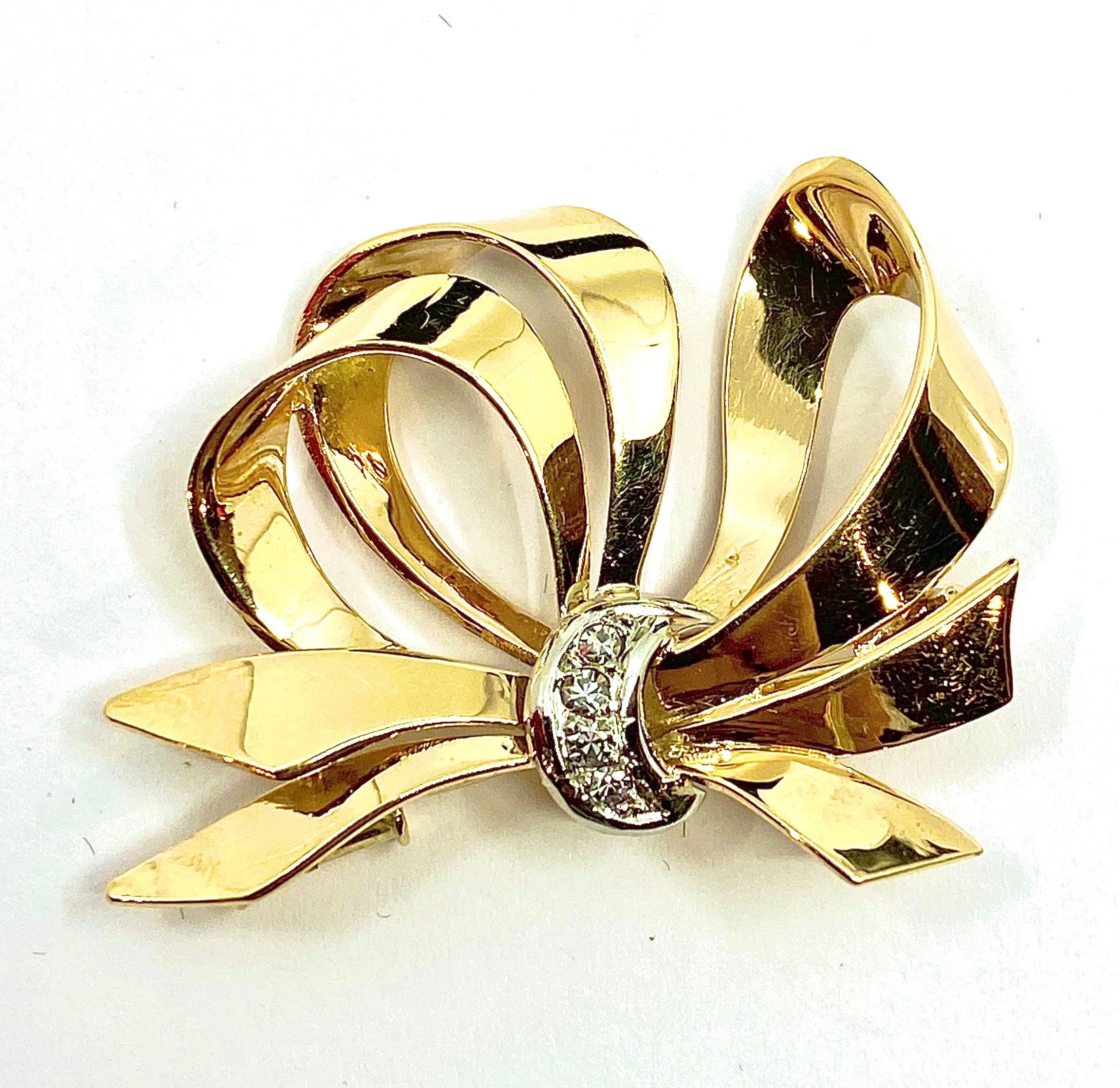 Gold, platinum, and diamond knot brooch