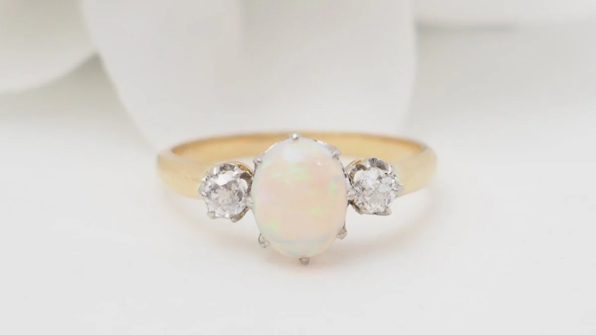 Yellow gold ring with oval opal and diamonds