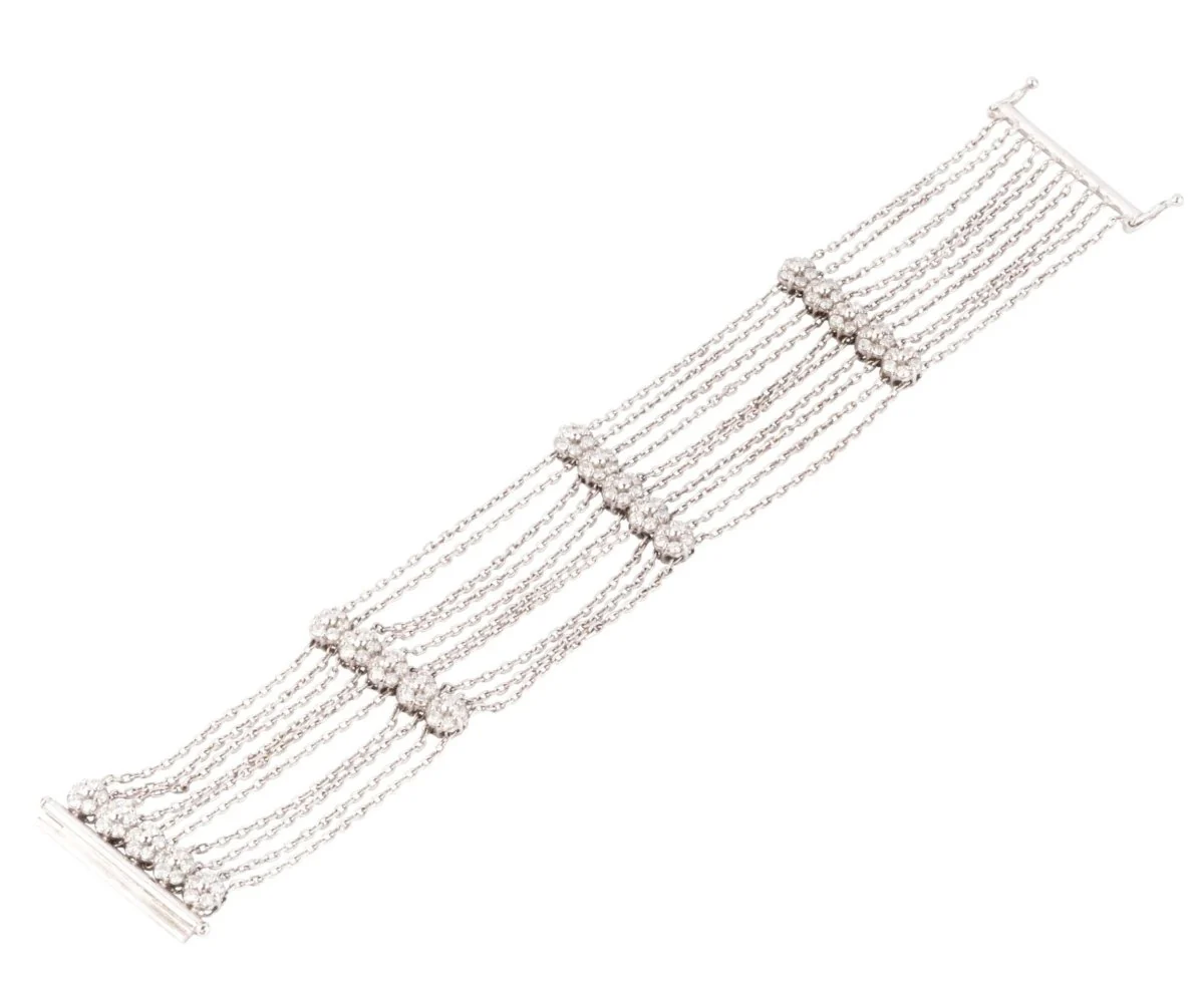 White gold and diamond bracelet on a filed força chain alternating with 4 patterns with flowers