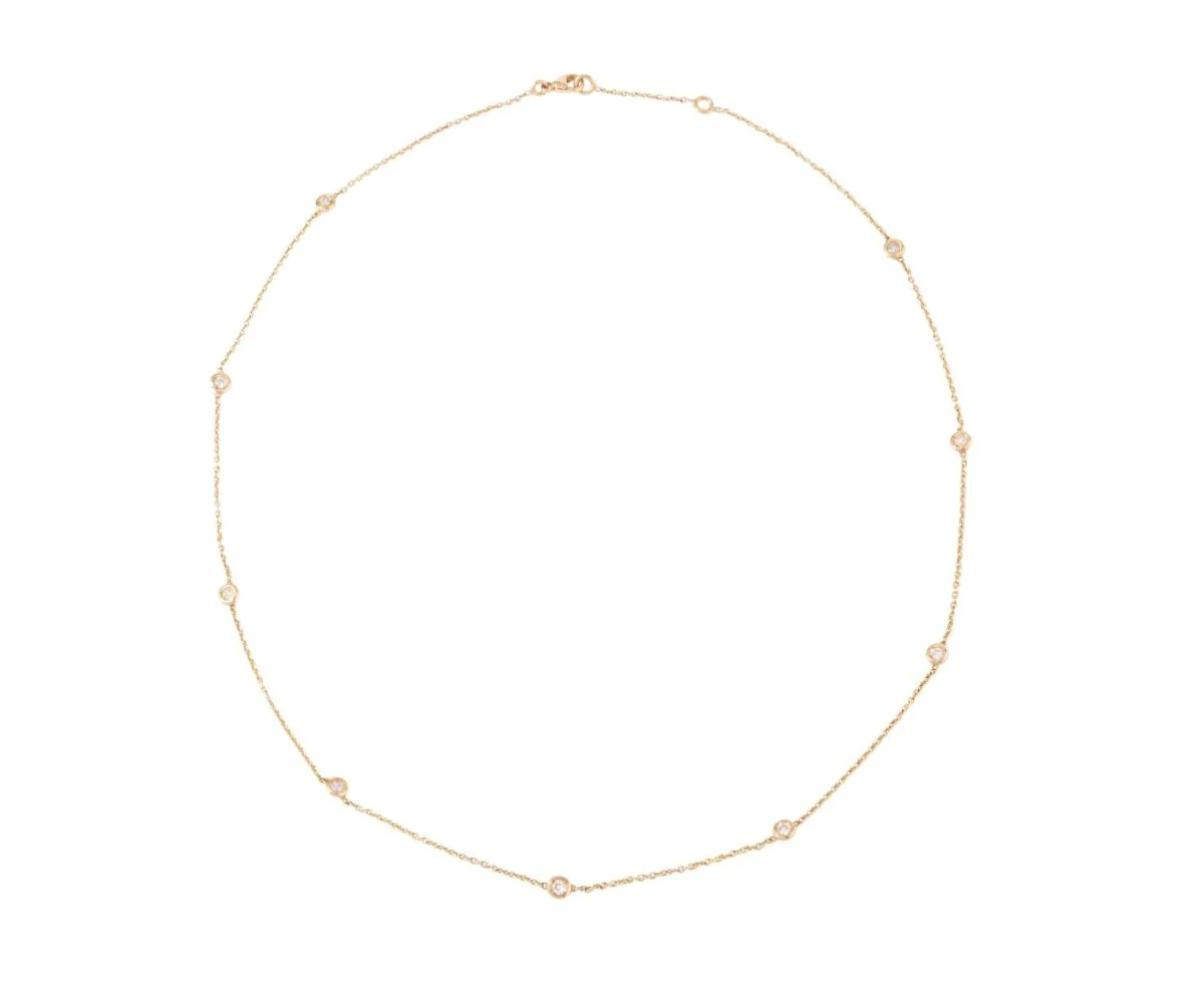 Yellow gold necklace interspersed with 9 diamonds on convict mesh in bezel setting.