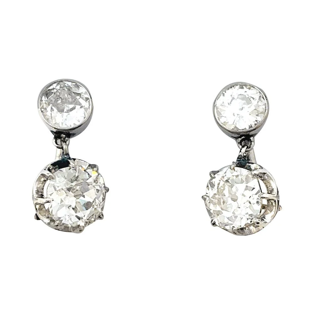 Pair of sleeper earrings in white gold rose gold, paltinium and diamonds antique cut.