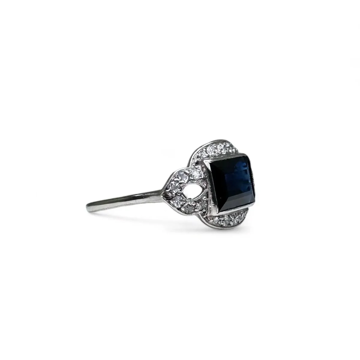 Platinum ring centered with a sapphire surrounded by diamonds. - Image 2