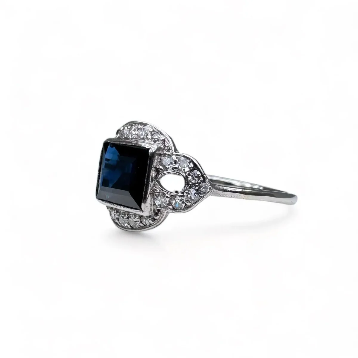 Platinum ring centered with a sapphire surrounded by diamonds. - Image 3