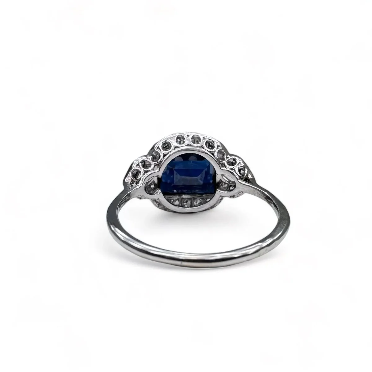 Platinum ring centered with a sapphire surrounded by diamonds. - Image 4